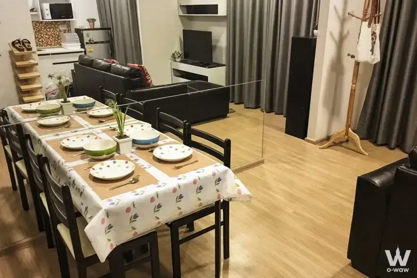 Fully furnished 2-bed condo dining area for sale in Plum Condo Bang Yai Station with floral tablecloth