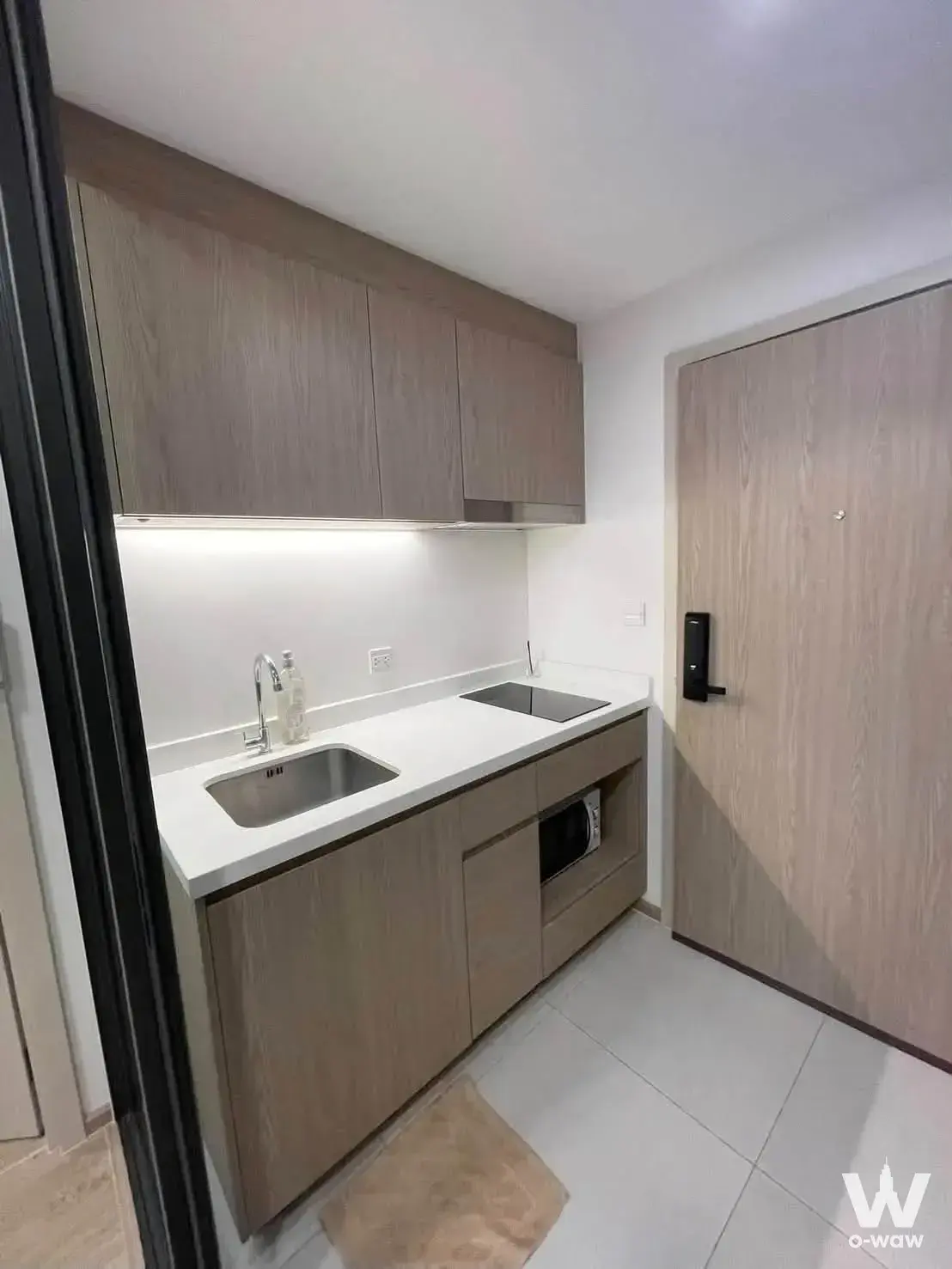 Compact modern kitchenette with induction cooktop in The Nest Chula-Samyan
