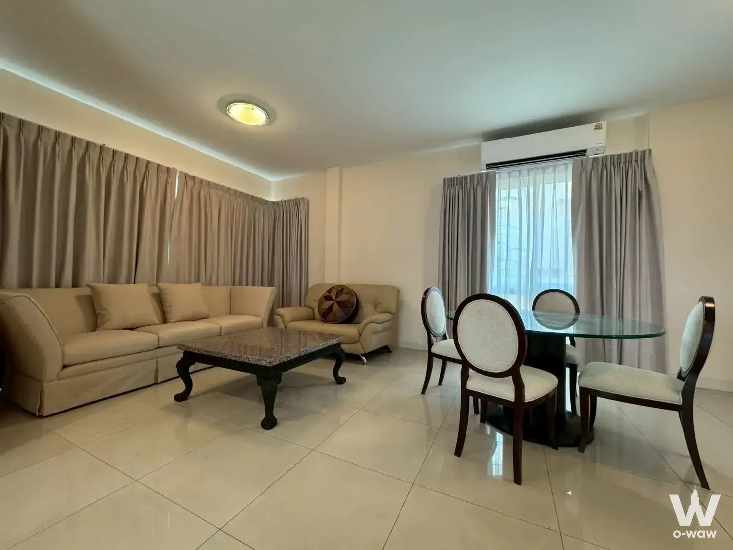Spacious living and dining area with beige tones in a 3-bed Bangkok Boulevard house