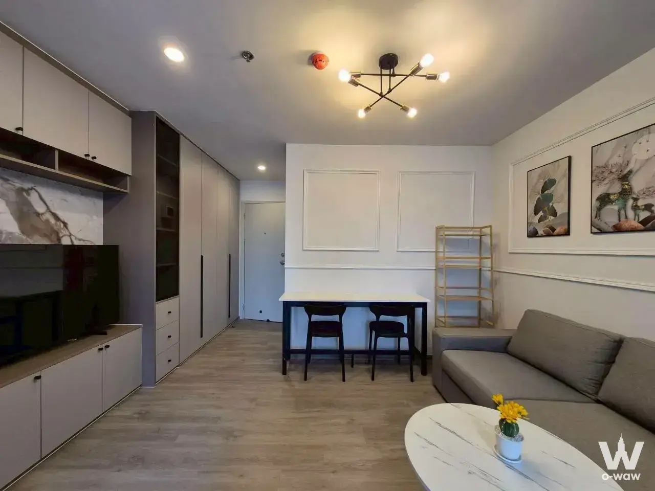 Furnished living and dining area in a 1-bed Regent Home Bangna condo with contemporary decor