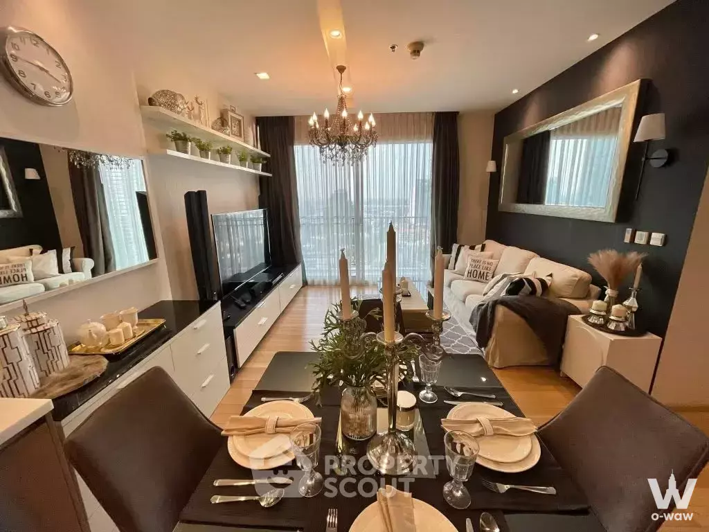 Furnished dining area in a Siri at Sukhumvit 2-bed condo with dark wood table, leather chairs, and city view