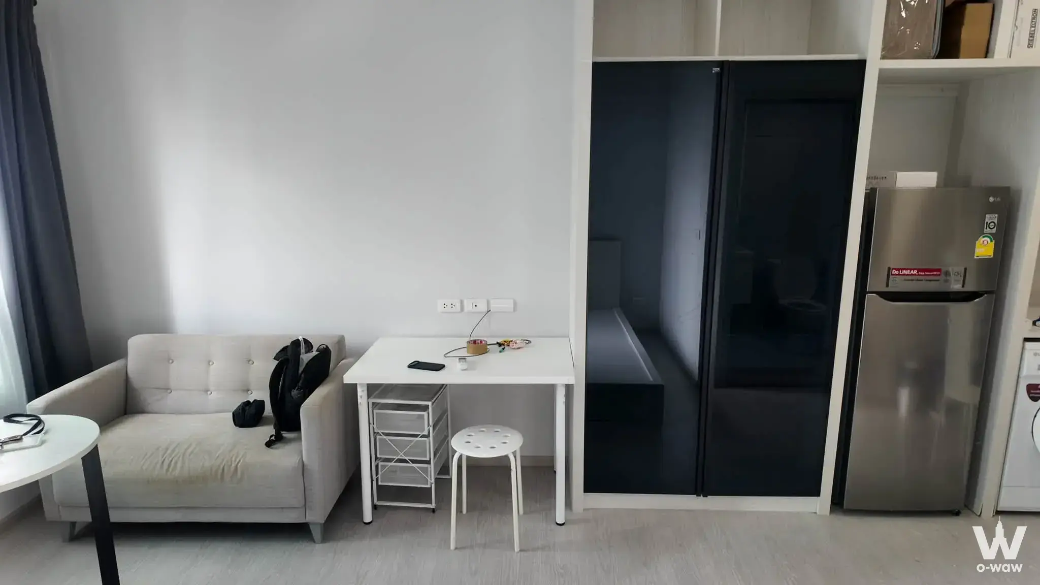 0-bed studio condo in Chapter One Shine Bangpo with sofa, desk, and built-in storage