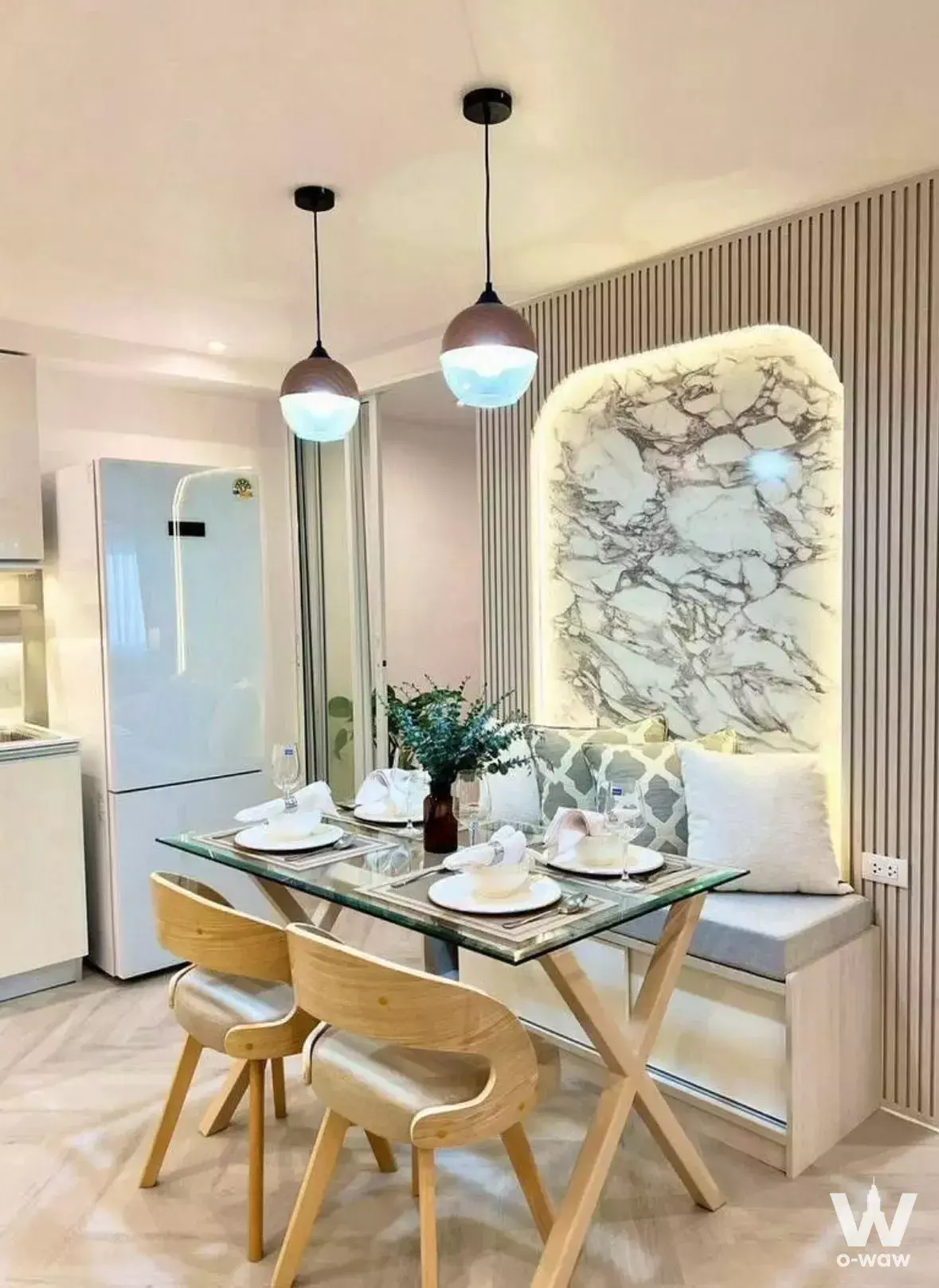 Glass dining table with wood slat wall and marble niche in a 3-bed condo for sale at Fortune CondoTown 1 Narathiwas