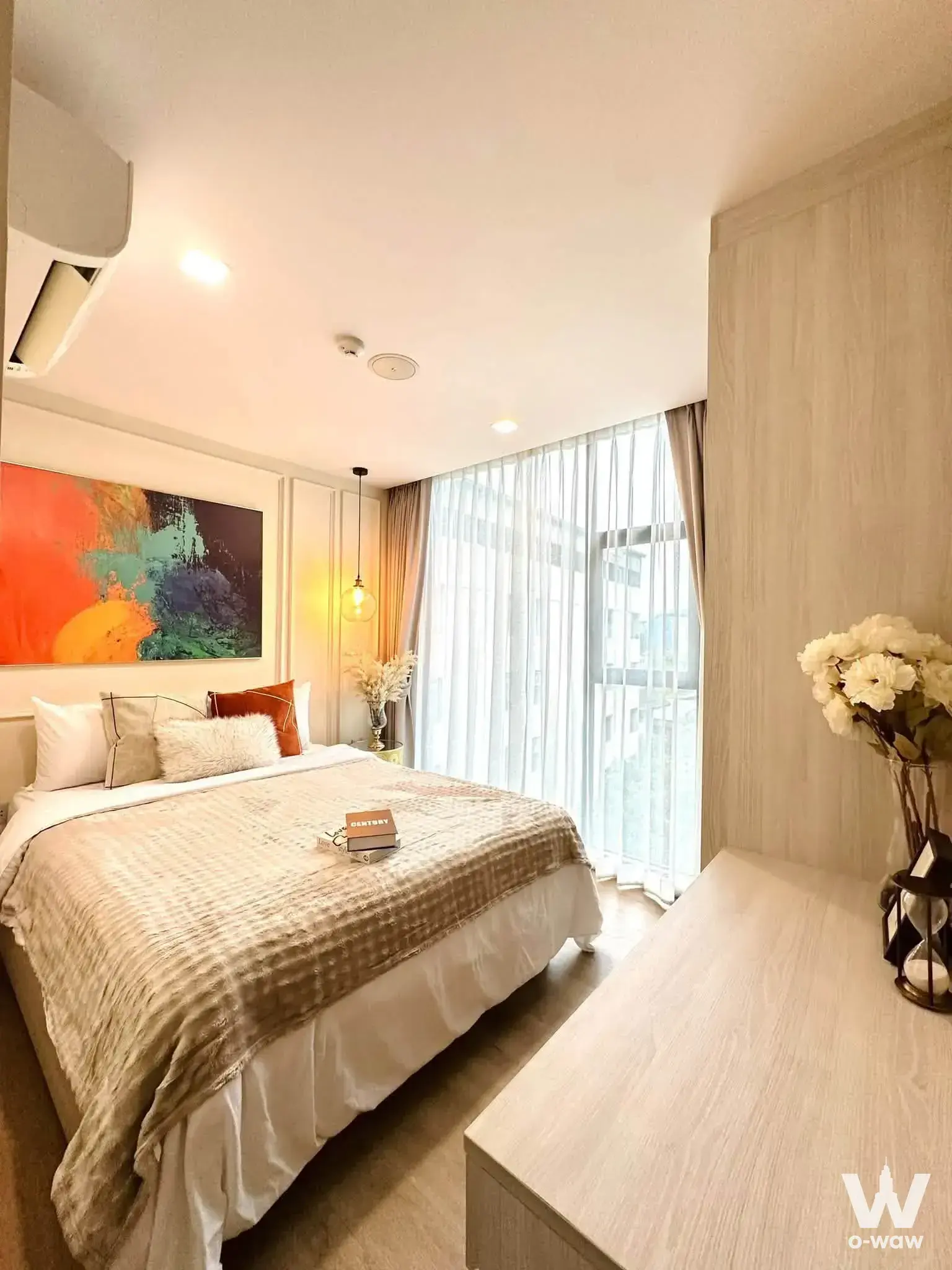 Ivory Ratchada 32 master bedroom with vibrant abstract art and city views