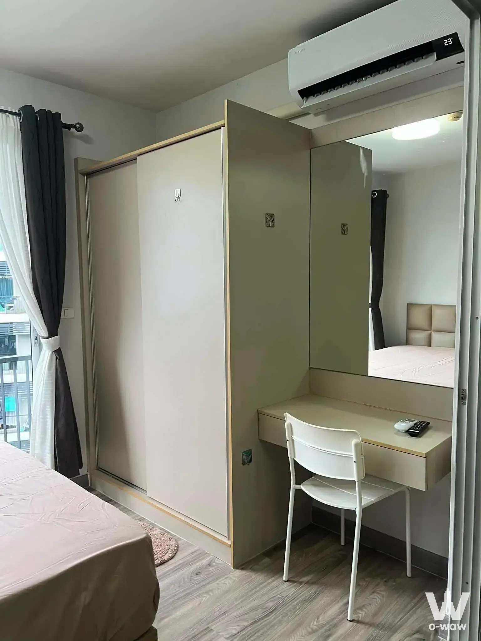 Beige headboard and built-in vanity desk in a furnished bedroom for rent at A Space ME Sukhumvit 77