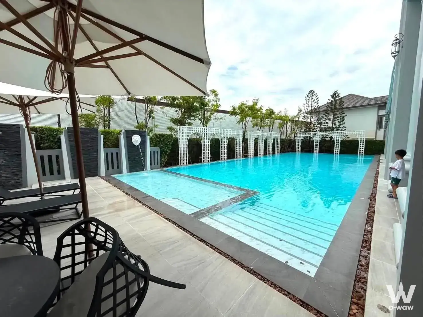 Resort-style pool with turquoise water and lounge chairs at Grandio Bangna KM.5