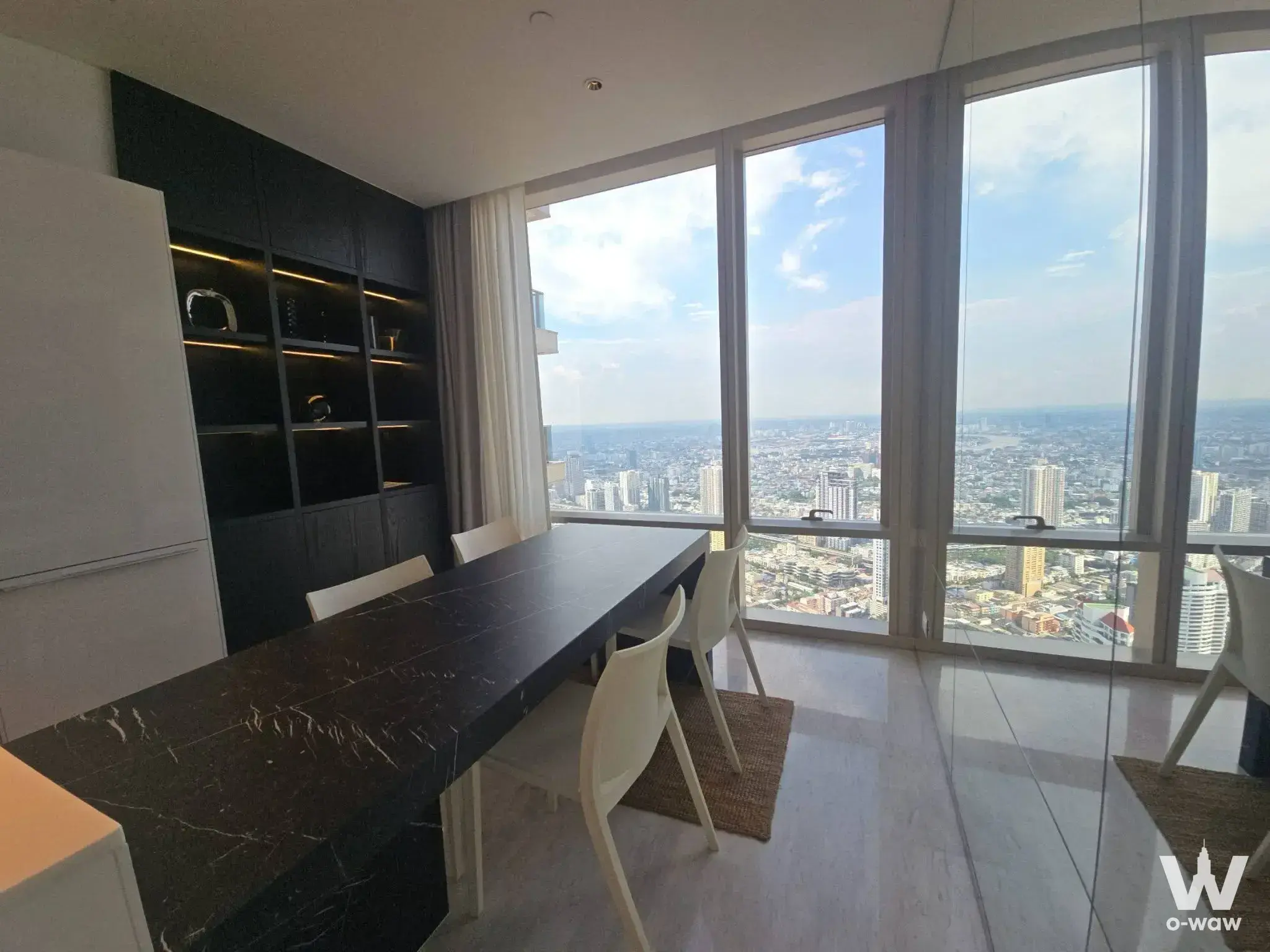 Dining area with marble table and river view at Four Seasons Private Residences