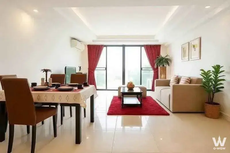 Open-plan living area with beige sofa and red accents in this M Ladprao 1-bed condo for rent