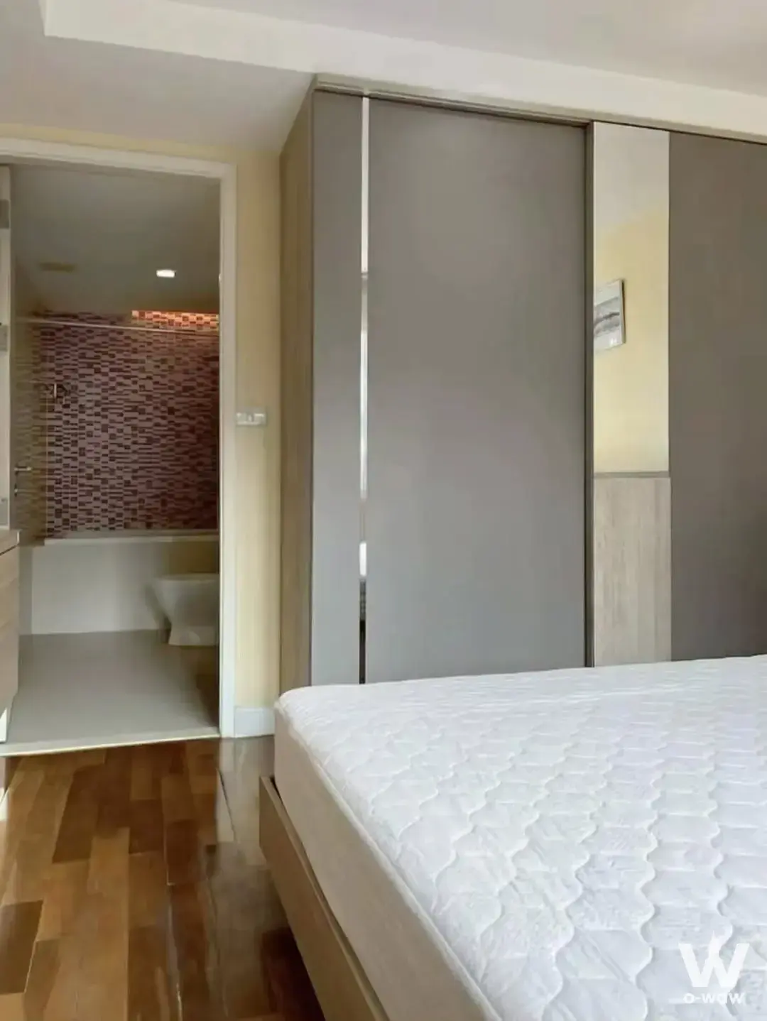Bedroom in a LE NICE CONDO rental featuring a queen bed, built-in wardrobe, and en-suite bathroom with mosaic tiles
