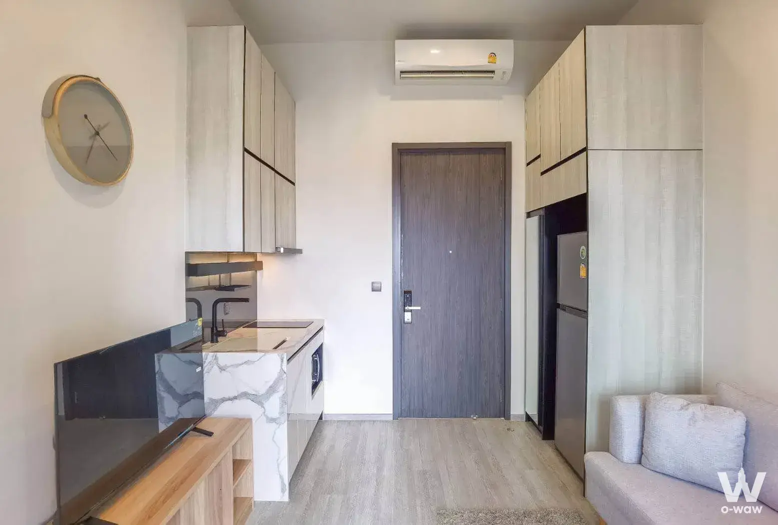 THE LINE Sukhumvit 71 open-plan studio with kitchenette island, wood flooring, and smart lock
