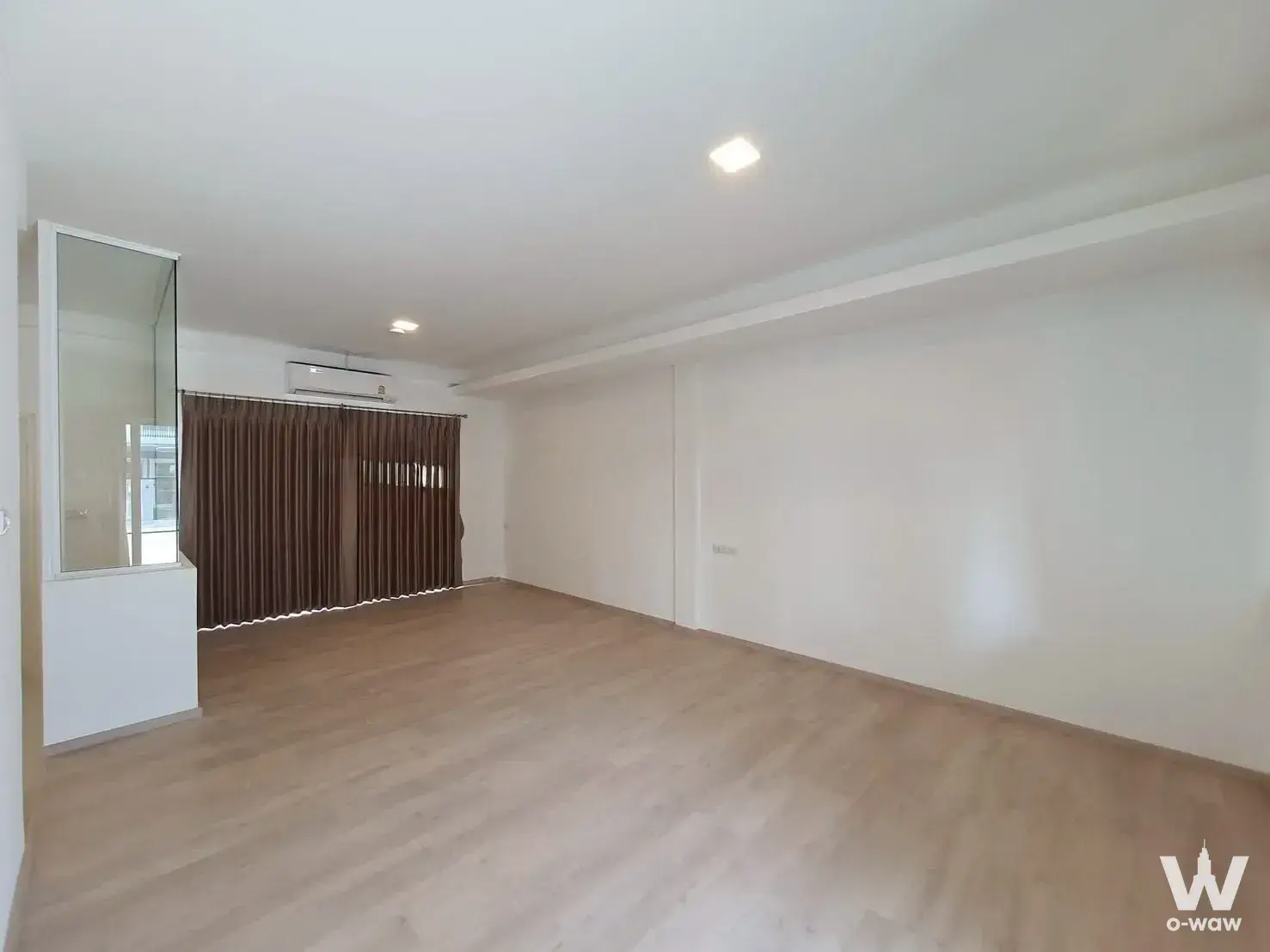 Bright unfurnished living room with floor-to-ceiling brown curtains in a 3-bed townhouse for rent in Indy 2