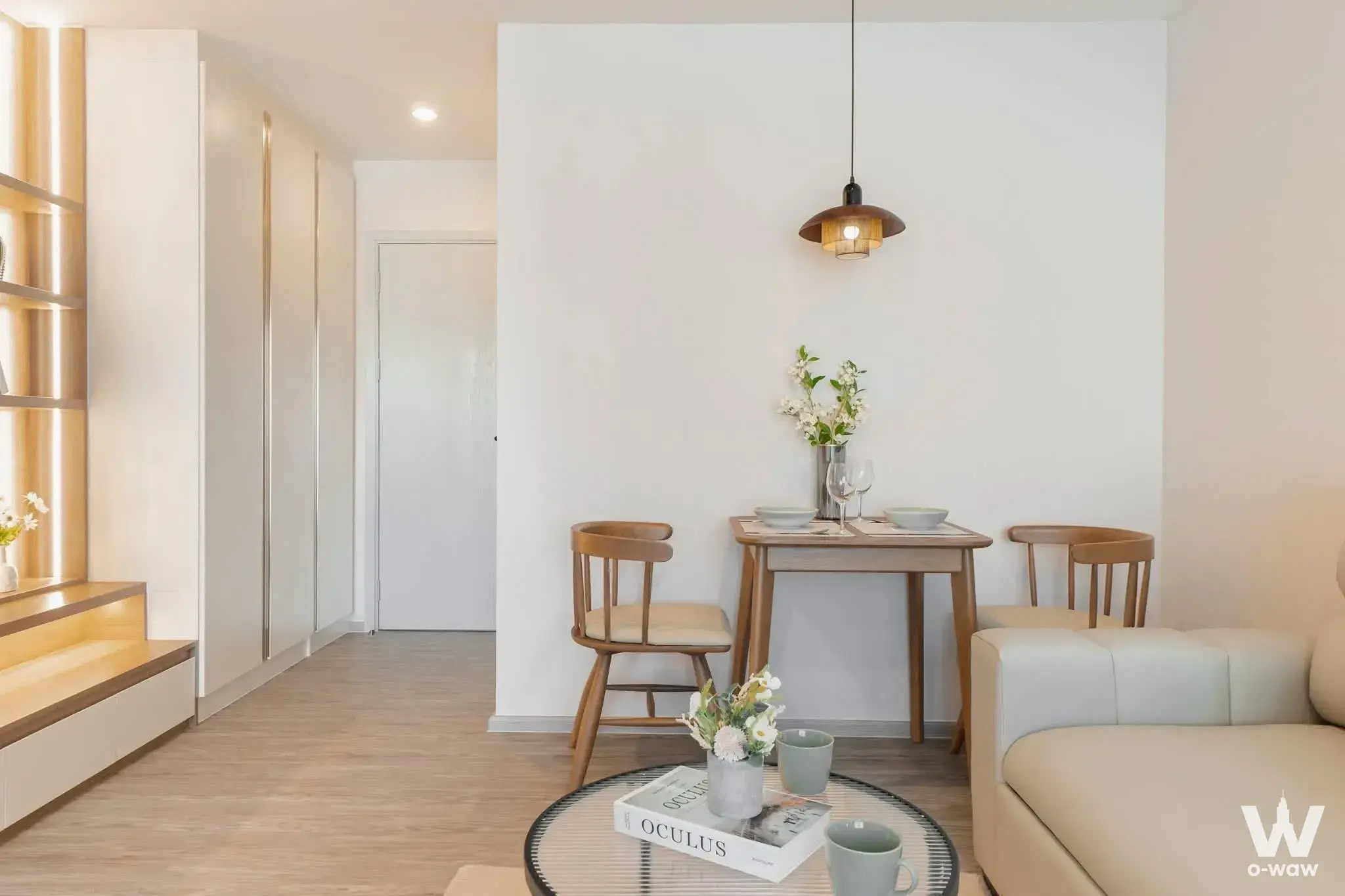Bright dining nook in a Regent Home Bangna condo with light oak table and built-in shelving