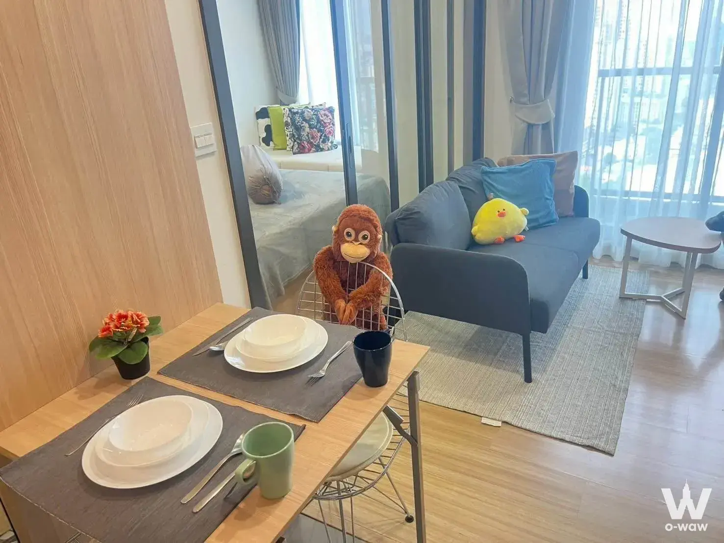 Bright 1-bed condo for rent in M Jatujak with light wood flooring and playful plush toys