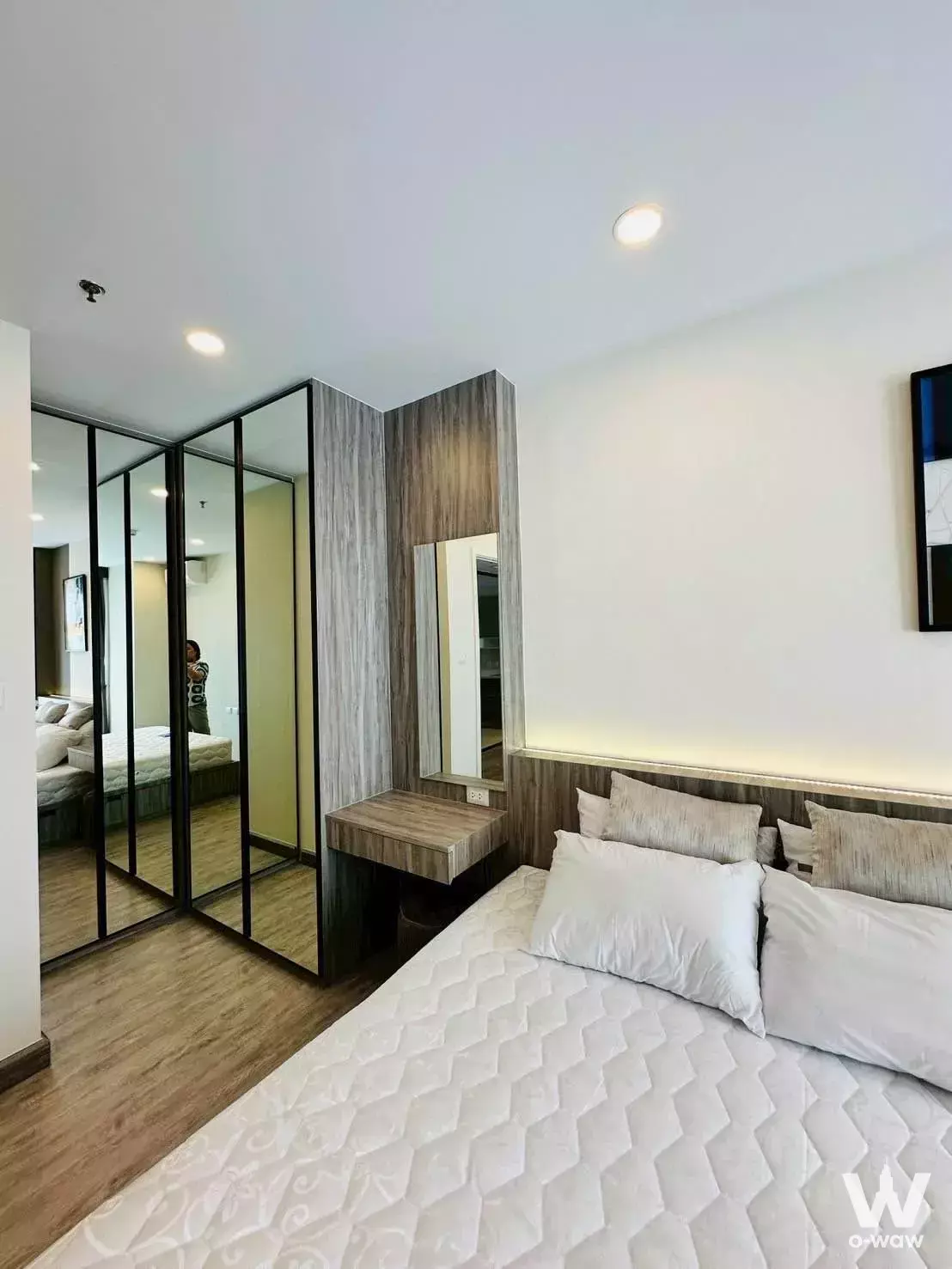 Modern 1-bed condo bedroom in Supalai Premier Charoen Nakhon with LED lighting and mirrored closet