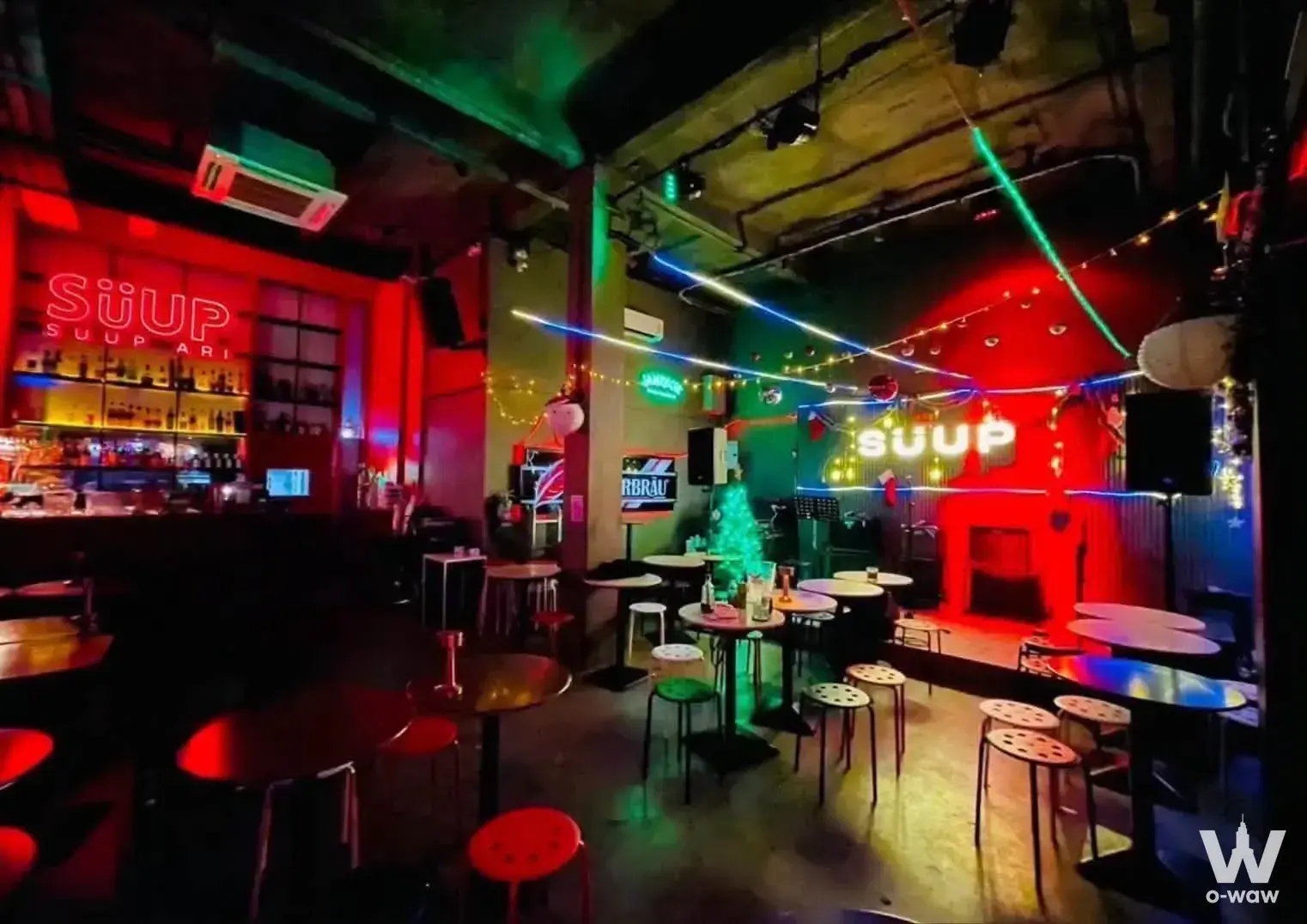 The Hub 0-bed commercial nightclub bar interior with neon signs and stage