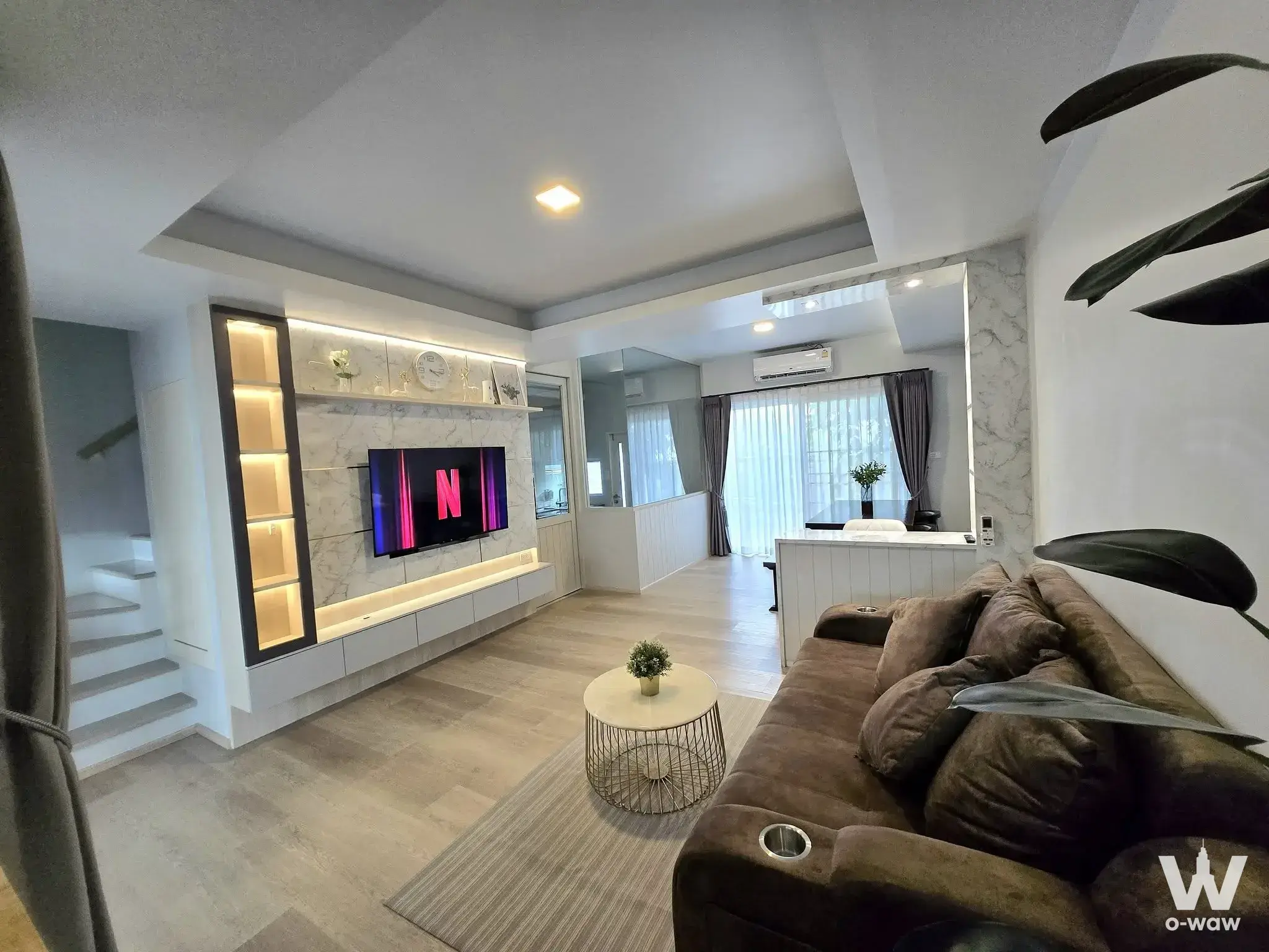 Living room of a 3-bed townhouse in Indy1 Bangna featuring dark velvet sofa and marble coffee table