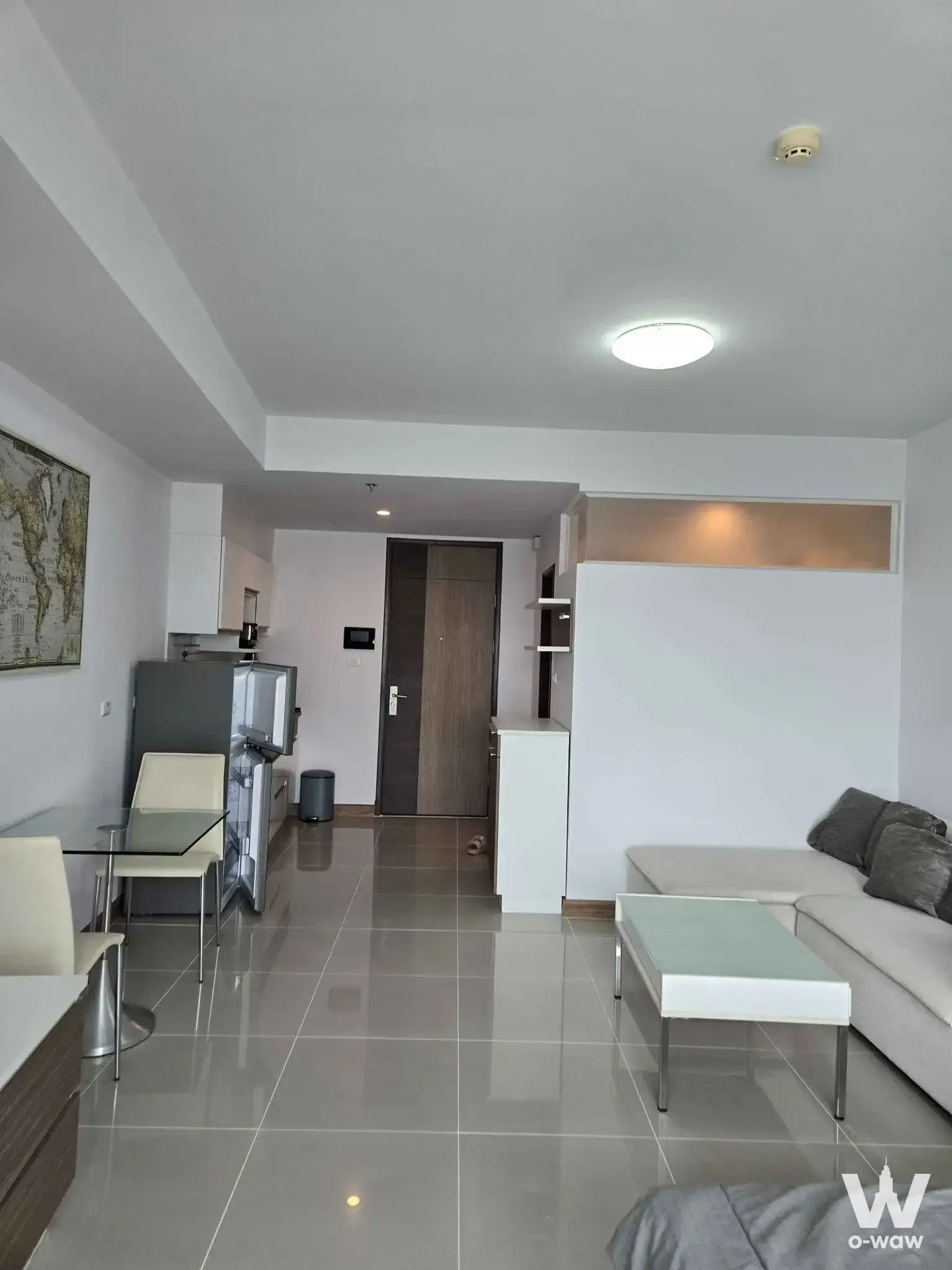 1-bed condo for rent in Supalai River Resort with grey tile living room and L-shaped sofa