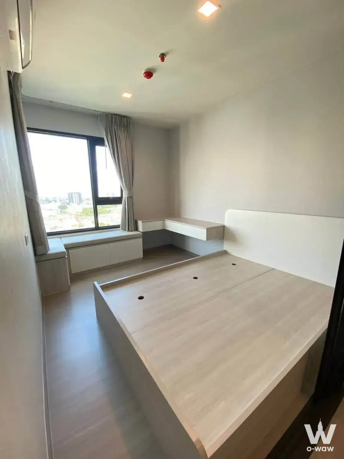Bedroom in a Life Sathorn Sierra condo with a built-in platform bed and large sliding glass window