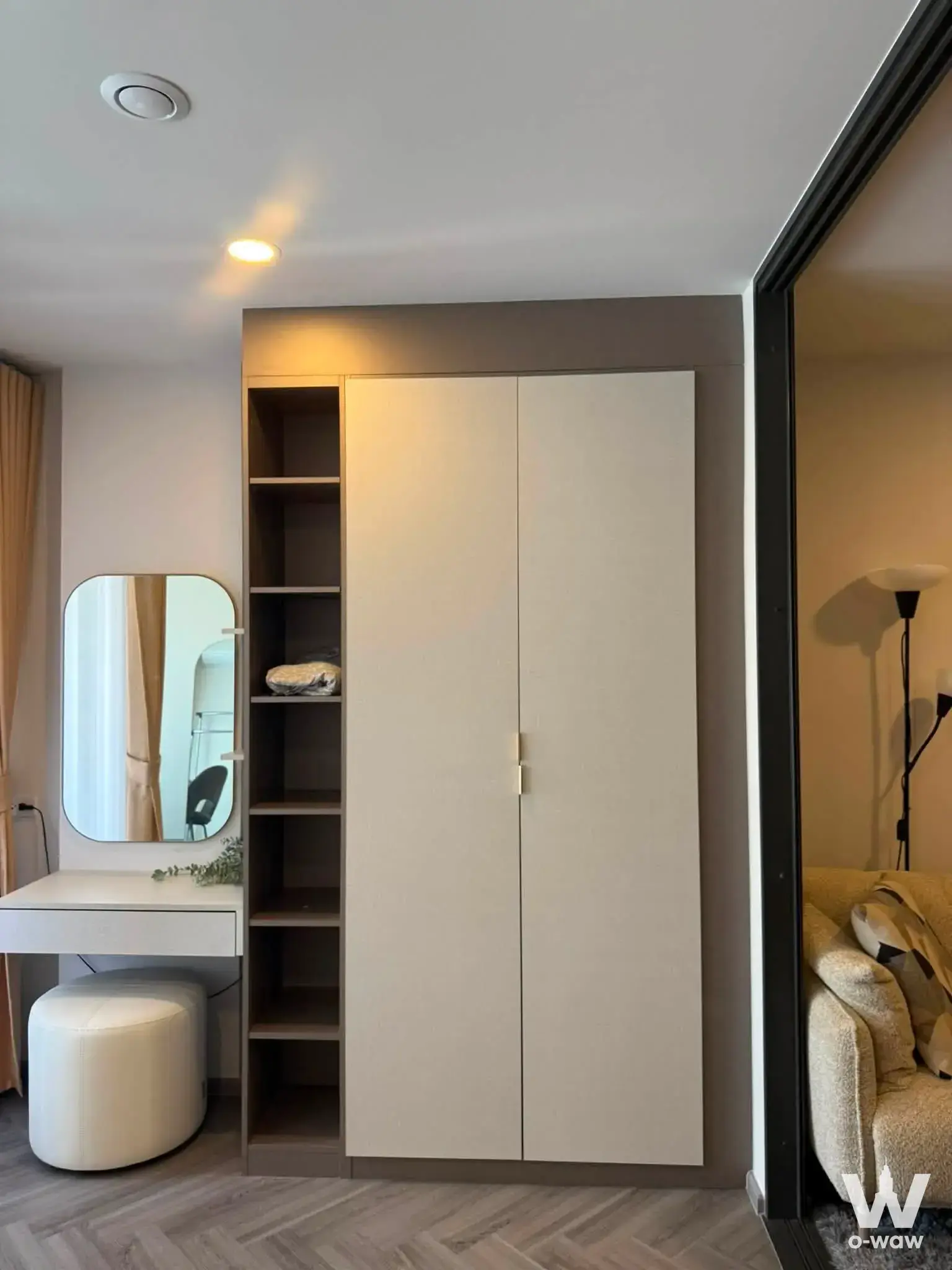 Bedroom corner with built-in cream wardrobe and floating vanity desk in an Aspire Arun Privé condo