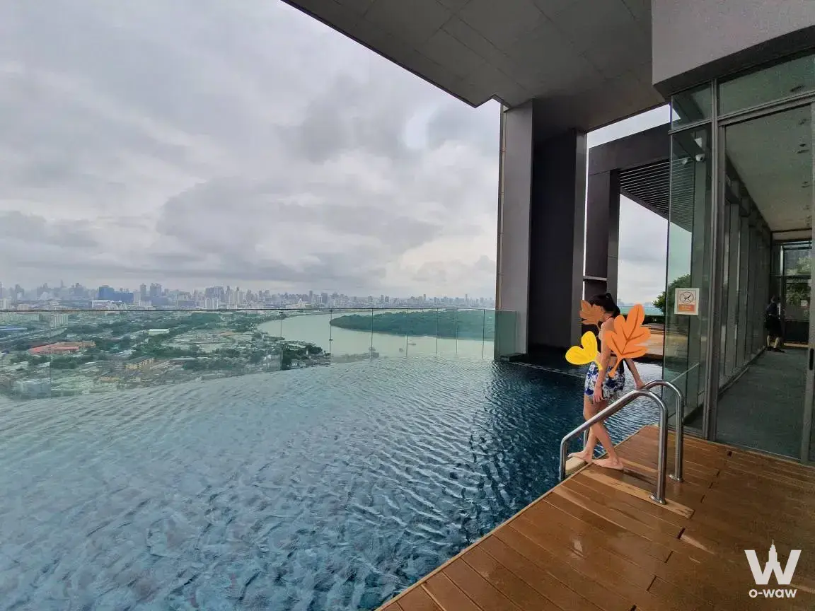 Rooftop infinity pool with city skyline view at The Breeze Naradhiwas