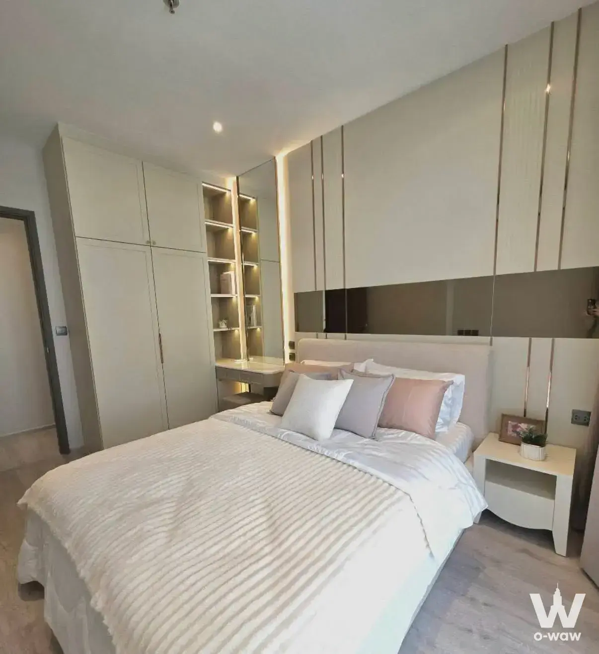 Rhythm Ekkamai Estate master bedroom featuring cream paneled wall and built-in wardrobes