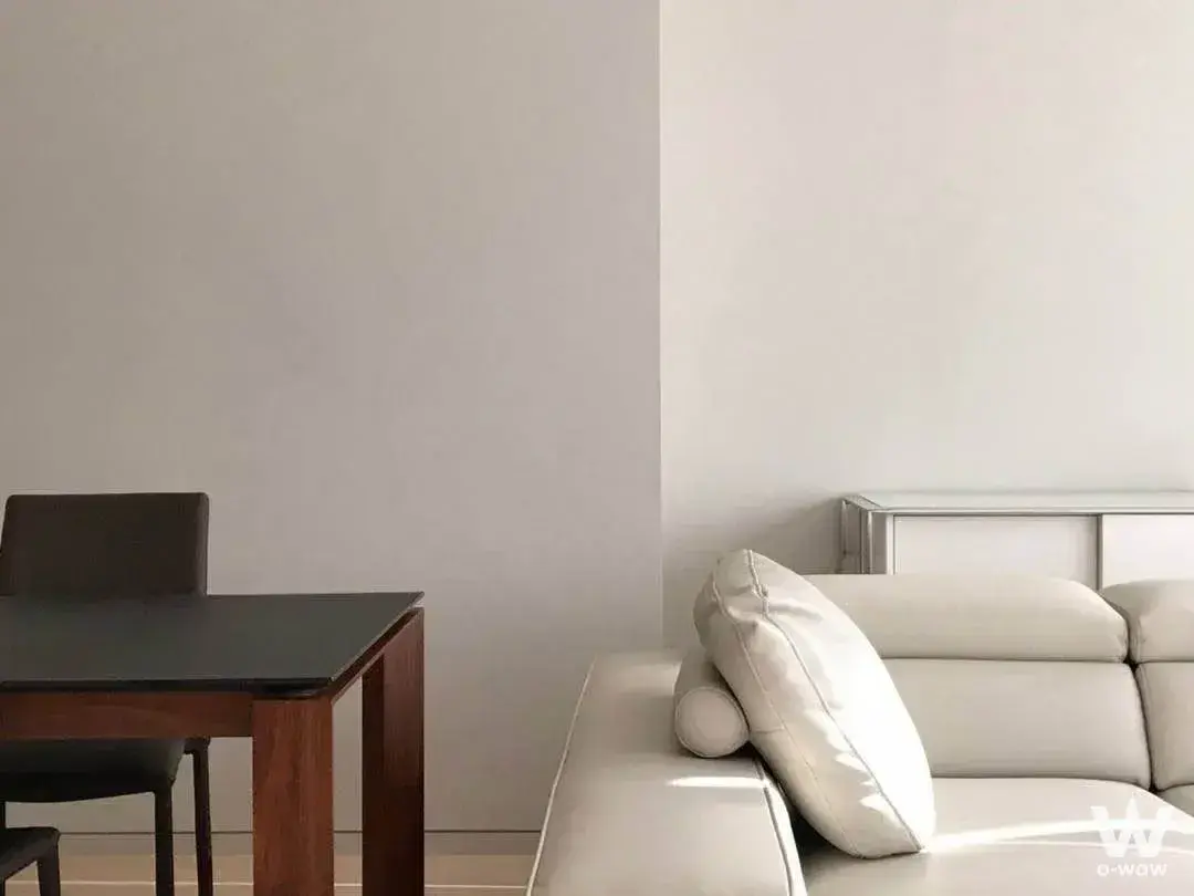 Modern 2-bed condo for sale in Tela Thonglor with cream leather sofa and natural sunlight