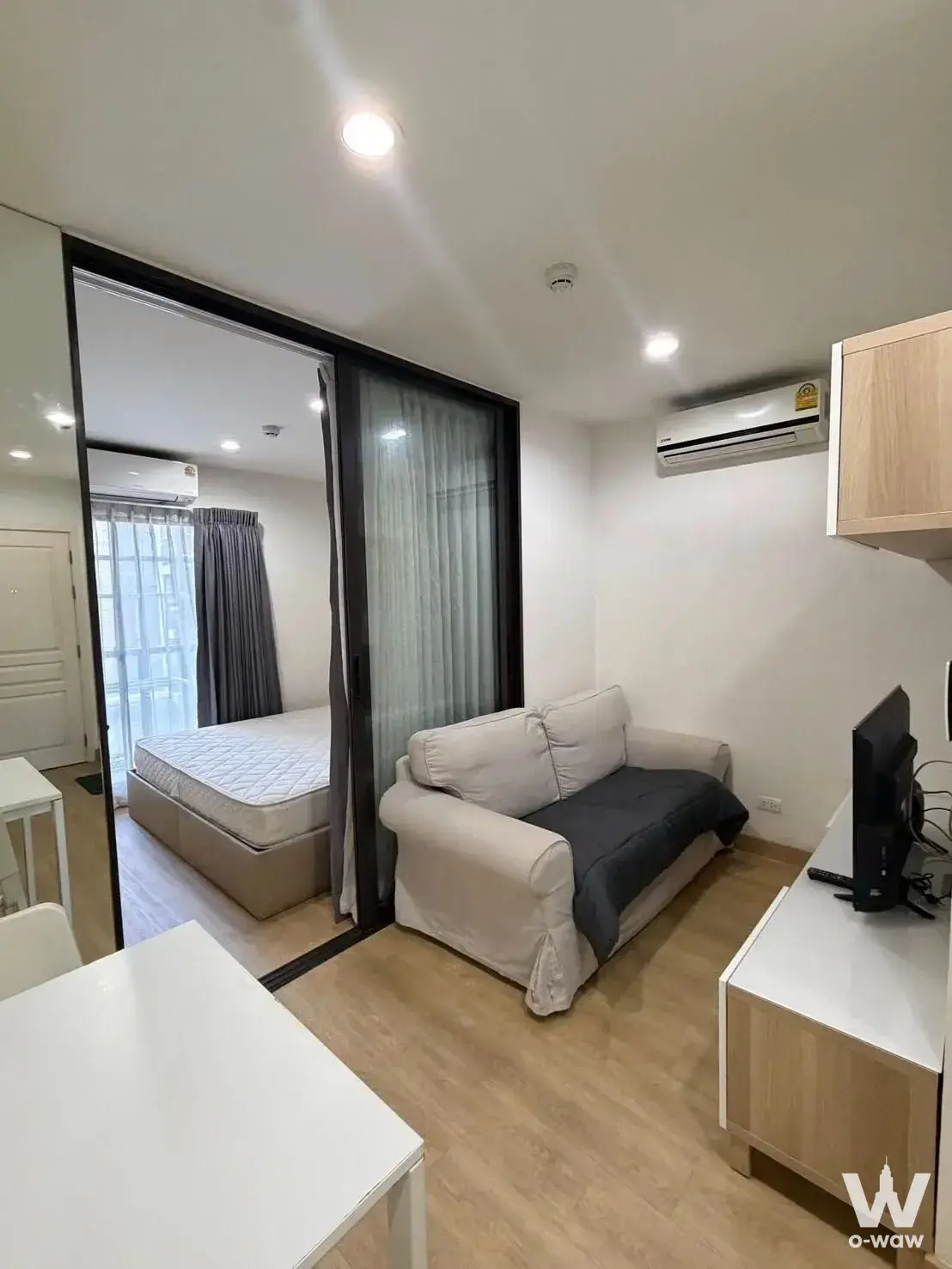 The Nest Sukhumvit 22 studio apartment with sliding glass partition separating the sleeping area