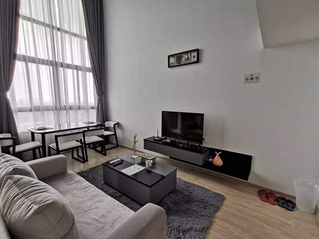 Furnished living room in Ideo New Rama 9 with floor-to-ceiling windows and dining set