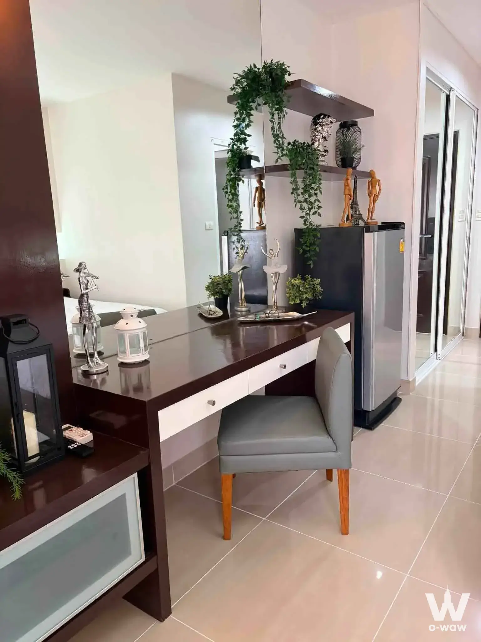 Staged living corner with mahogany desk and mini-fridge in a 1-bed house for rent at i-House Laguna Garden RCA