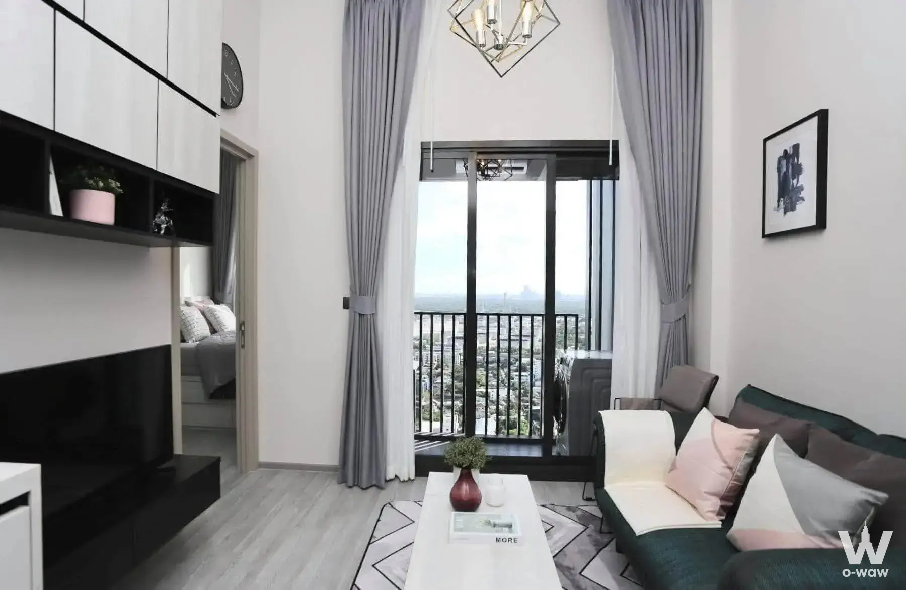 Modern 1-bed condo living room in THE LINE Sukhumvit 71 with green sofa, city view and gold chandelier