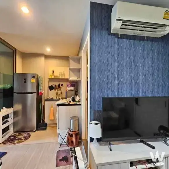 Open-plan space in ASPIRE SATHORN-RATCHAPRUK with blue accent wall and compact kitchenette