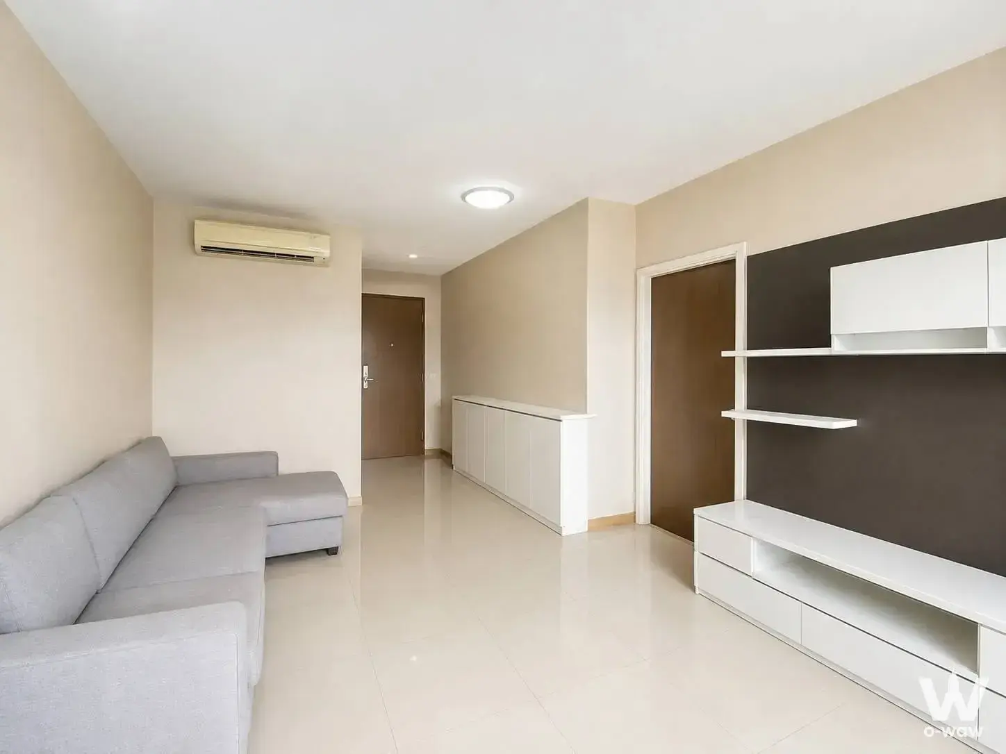 L-shaped sofa and media unit in living room of 2-bed condo for sale at Ivy River