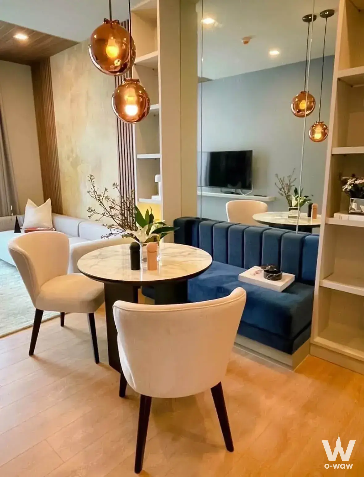 Noble Around Sukhumvit 33 dining space with copper lamps and blue banquette
