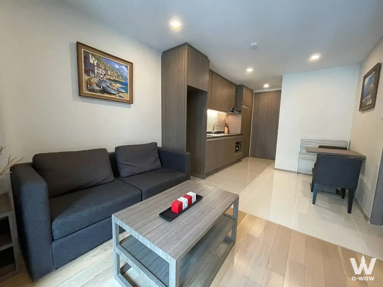 1-bed condo for rent in art @ Thonglor featuring dark-grey sofa and wood-look flooring