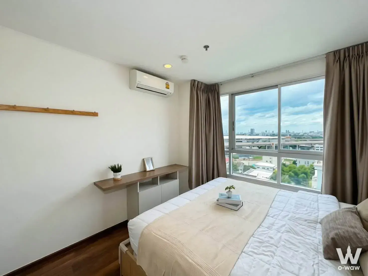 Bright bedroom in U Delight Rachavibha with a floating desk and large window overlooking the city