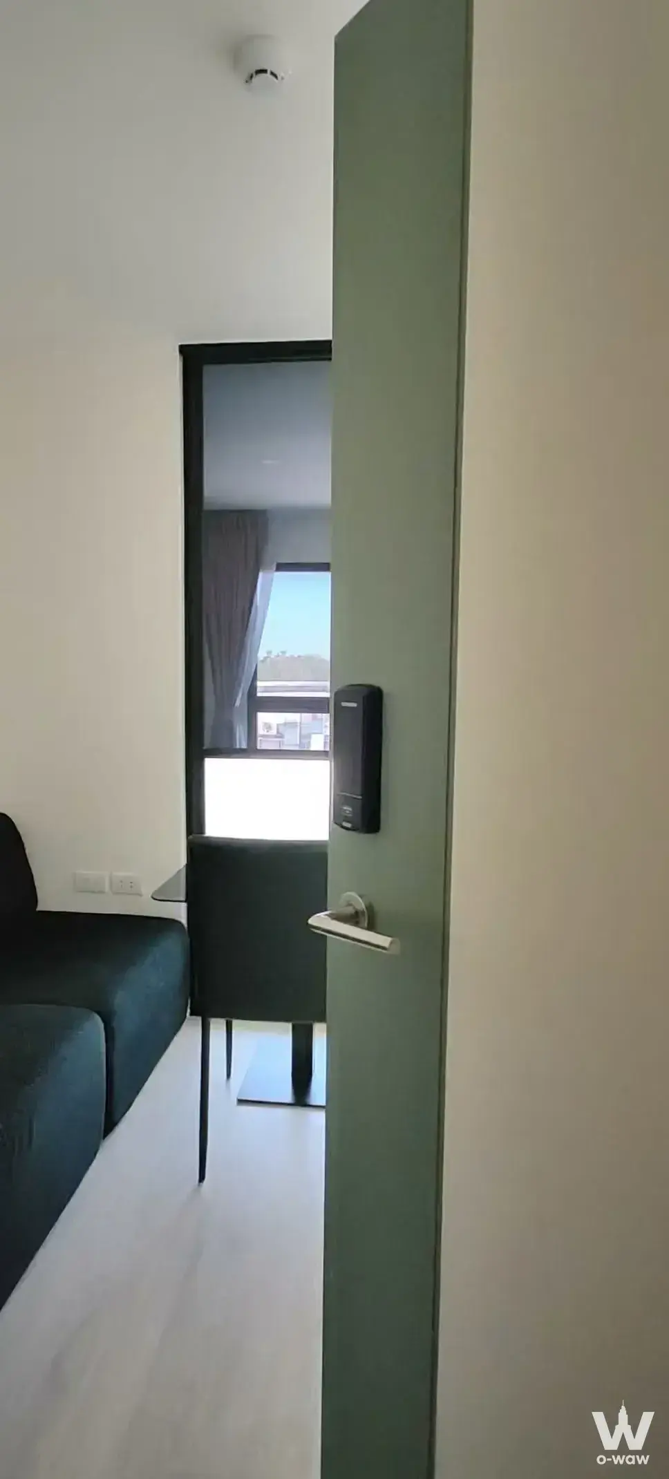1-bed condo for sale in iCondo Green Space Sukhumvit 77 featuring sage-green door and teal sofa