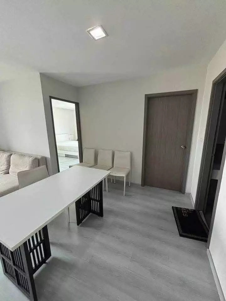 Dining area in Grene Chaengwattana featuring a modern table and open view into the bedroom