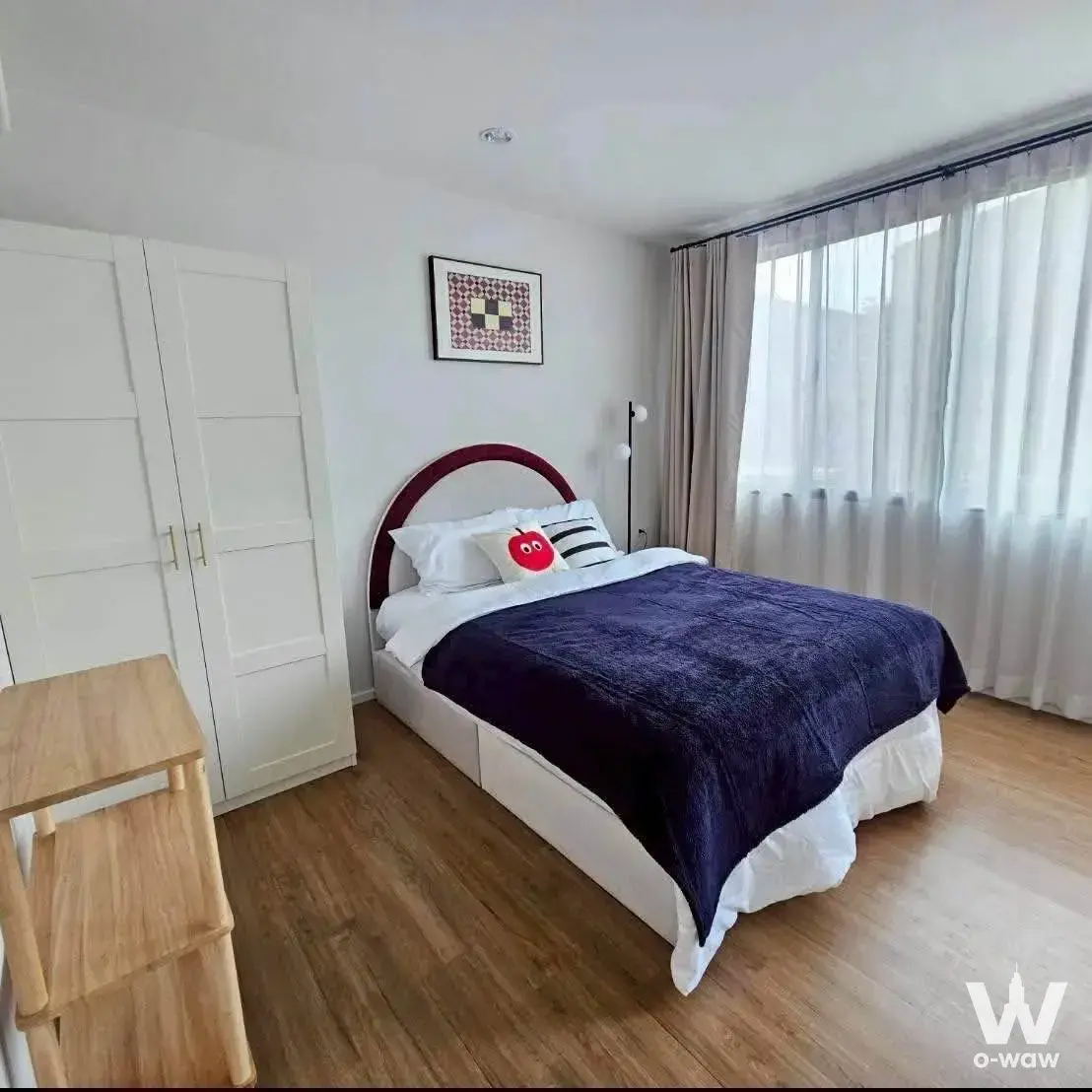 Bedroom in a 3-bed townhouse for rent at Baan Klang Muang Rama 9 featuring a burgundy headboard bed