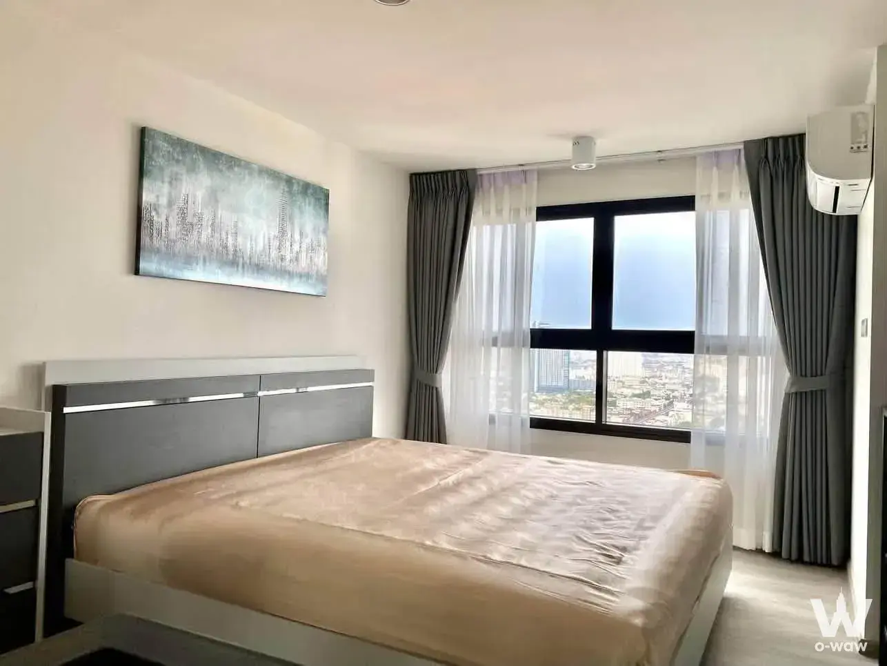Bedroom in 1-bed condo for rent in Ideo Charan 70 - Riverview featuring dark grey headboard and city view