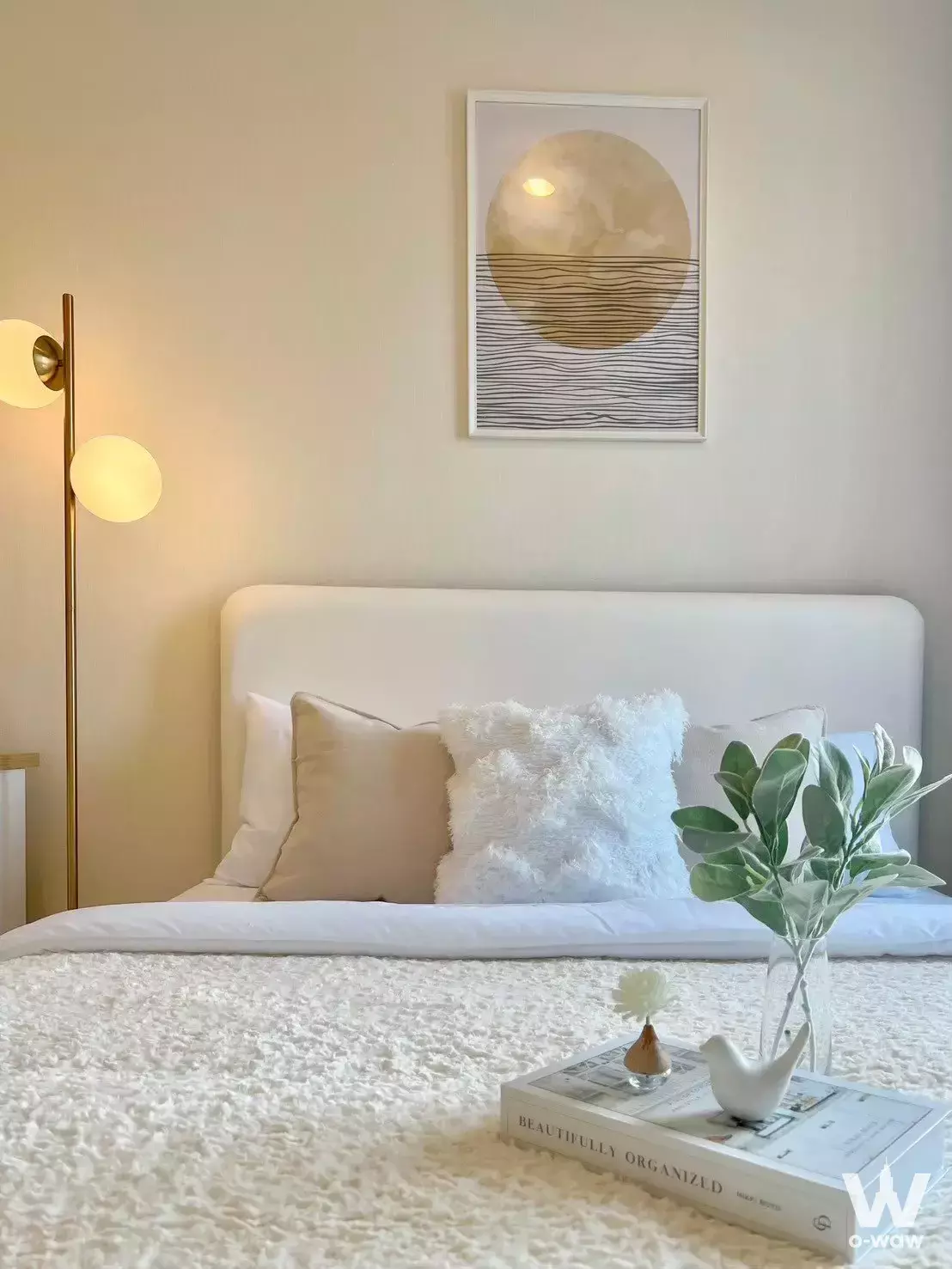 Staged bedroom in The Sky Sukhumvit condo with queen bed, abstract art, and warm ambient lighting