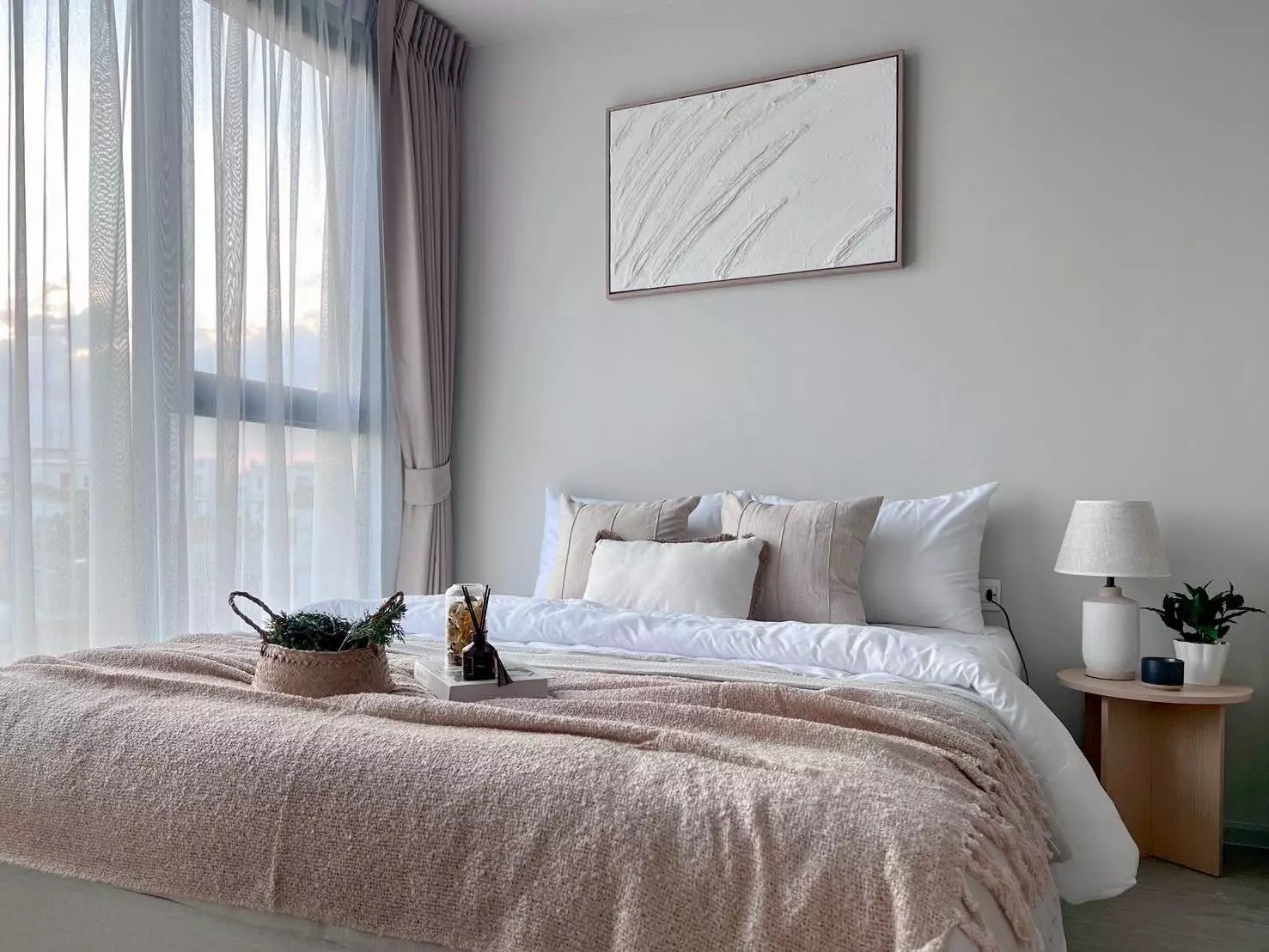 Serene bedroom in an Atmoz Oasis Onnut 1-bed rental with queen bed, natural light, and neutral tones