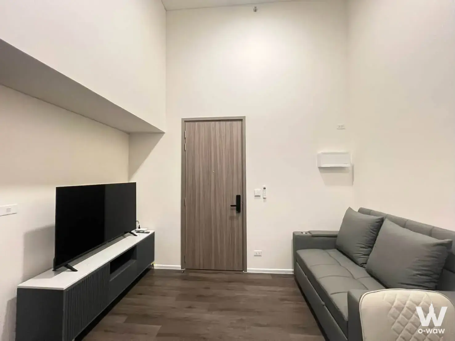 2-bed condo for rent in Landmark at Grand Station with dark wood flooring, sofa, and minimalist decor