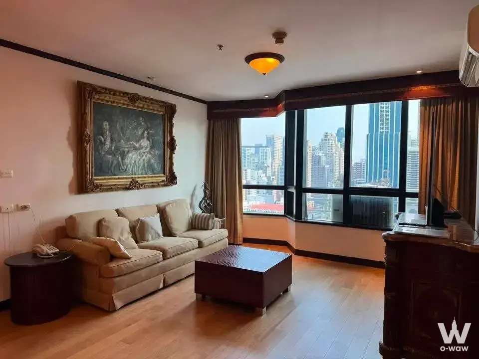 3-bed commercial for rent in President Place with a beige sofa, gold-framed painting, and city skyline view