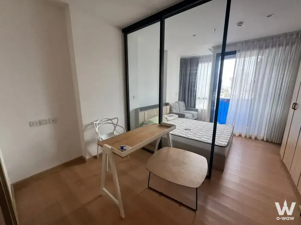 1-bed condo for rent in M Ladprao studio with open plan layout and glass partition separating sleeping zone