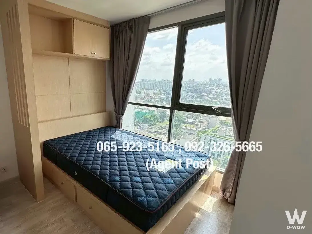 Ideo Mobi Sukhumvit 81 1-bed bedroom with built-in wardrobe, navy mattress, and large window overlooking the city
