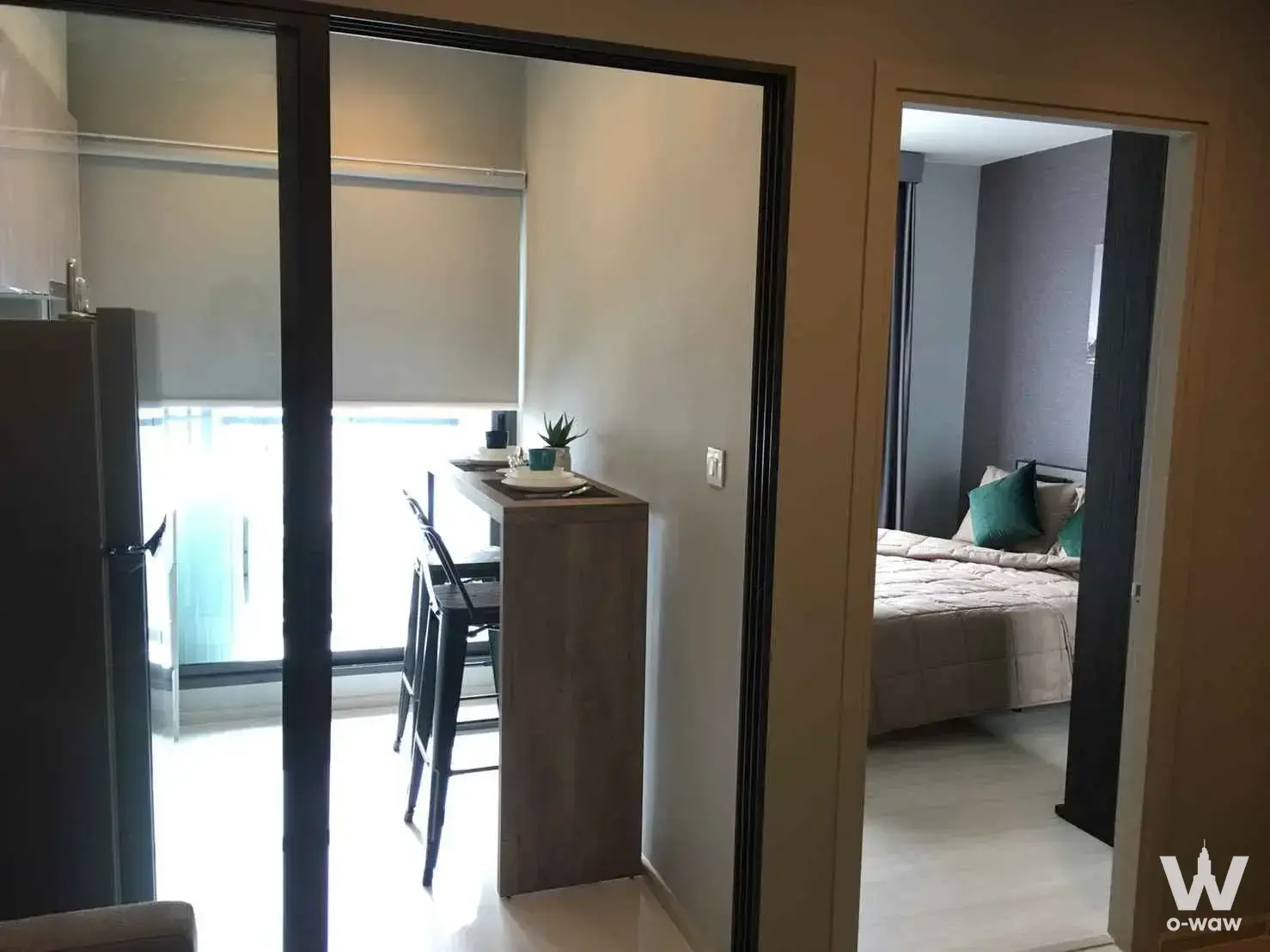 Bright open-plan rental in Life Sukhumvit 48 with floor-to-ceiling glass doors and a modern kitchenette
