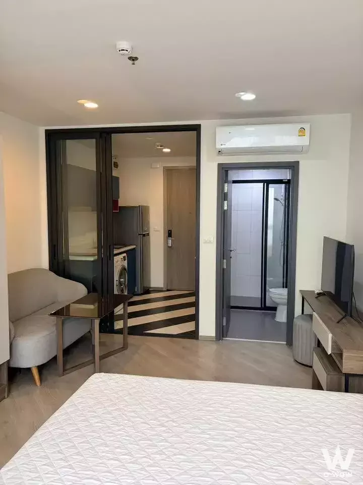 THE BASE Saphanmai studio apartment with sliding glass partition separating the kitchenette