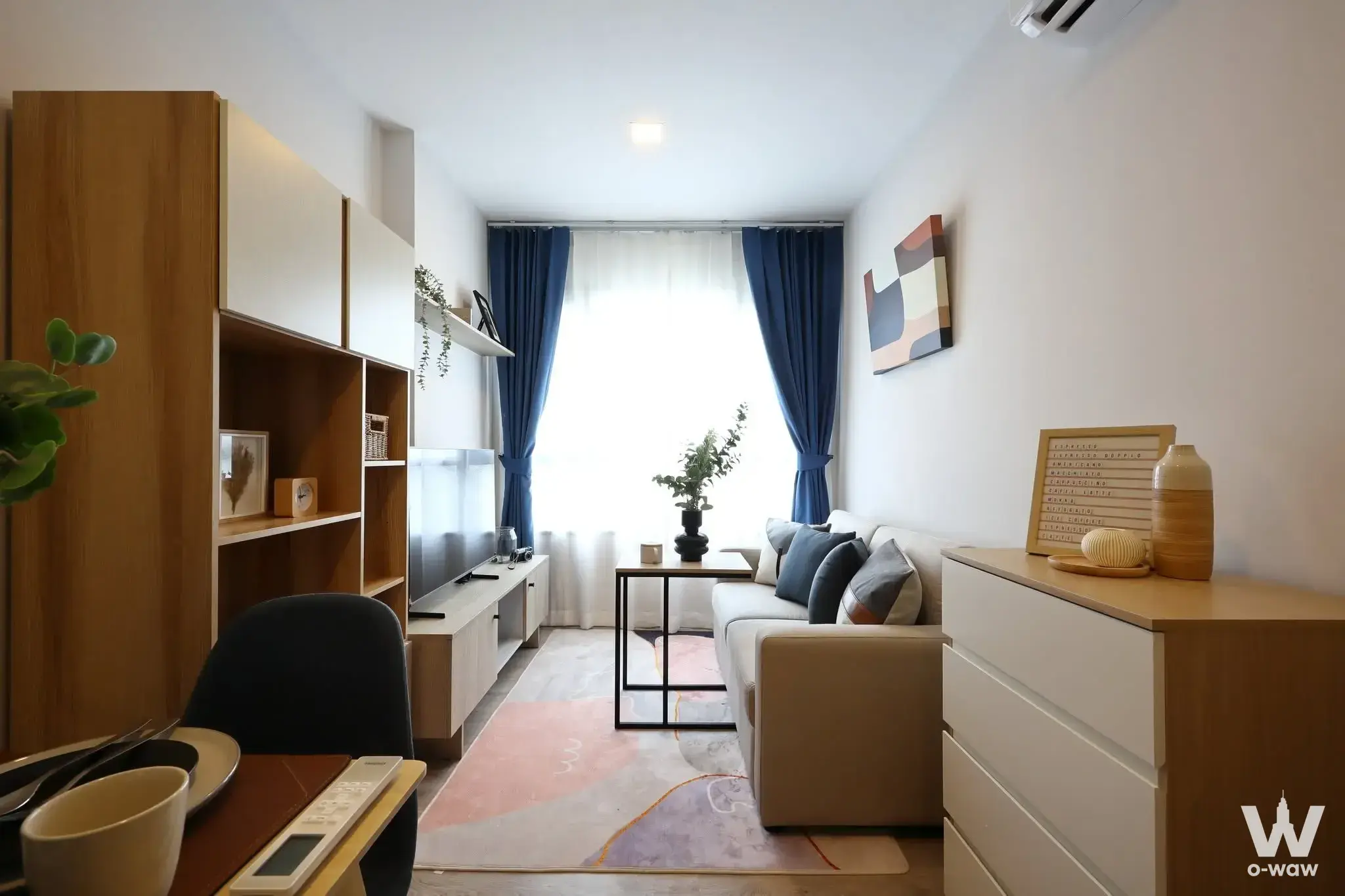 Modern 1-bed condo living room in THE BASE Height-Chiang Mai with light-wood storage and minimalist decor