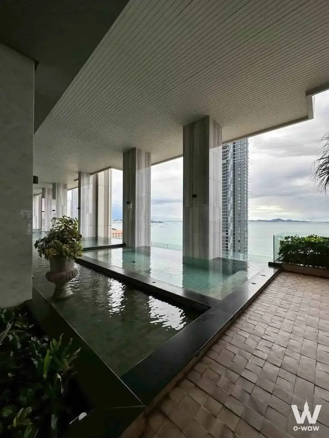 Infinity pool deck at The Riviera Wongamat Beach condo overlooking the sea and distant islands