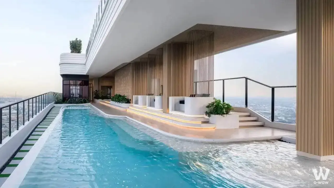Rooftop infinity pool with turquoise water and city skyline views at Xim Rama 3 - Suksawat